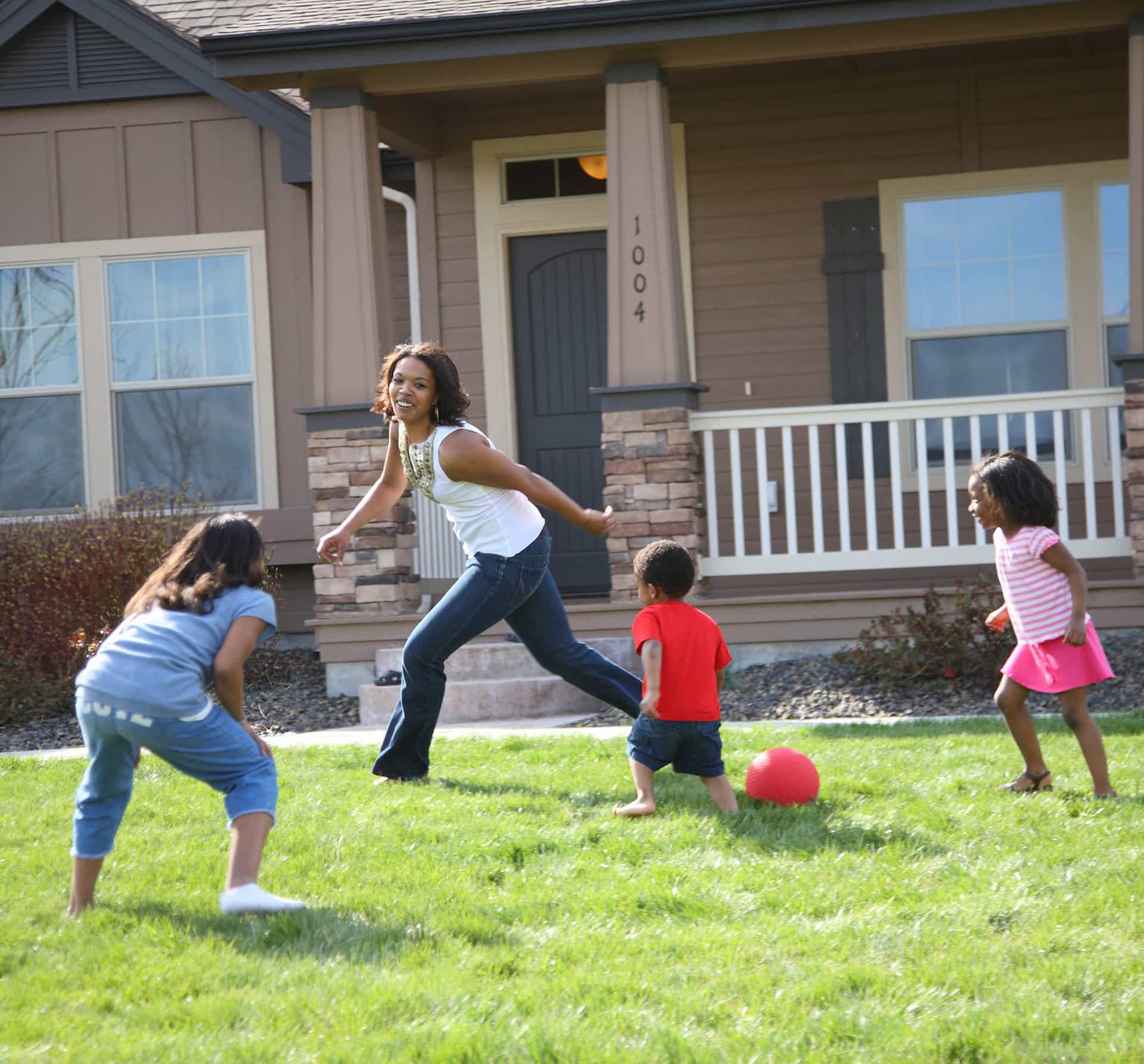 kids playing outside of their custom home